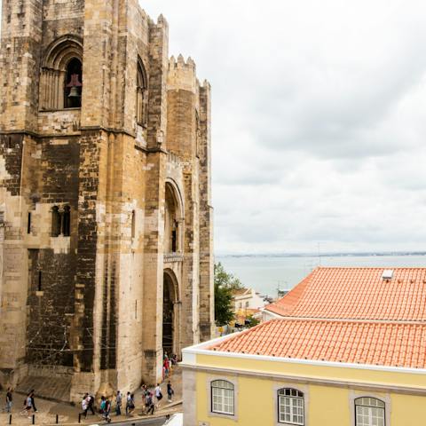 Look out over Lisbon Cathedral and the terracotta rooftops of Alfama from your apartment