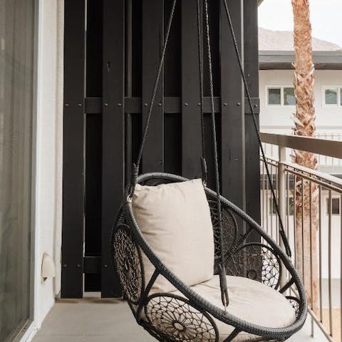 Chill on the funky swinging egg chair on your private balcony