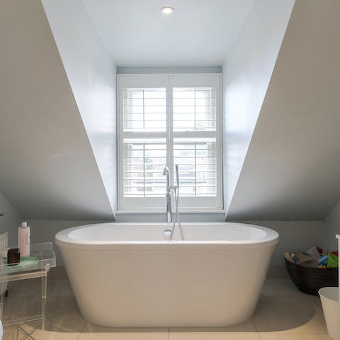 Treat yourself to a restorative soak in the elegant freestanding bathtub