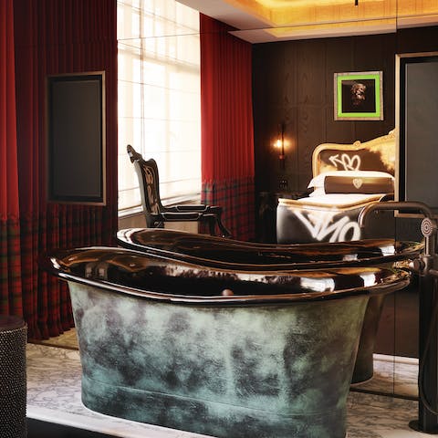 Relax and unwind in the luxurious freestanding bathtub 