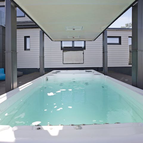 Enjoy lazy afternoons in the hot tub or swim against the stream in the swim spa