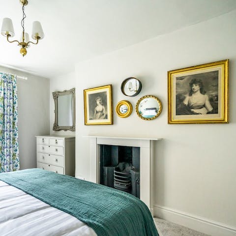 Wake up to a classy collection of historic art and mirrors in the bedroom