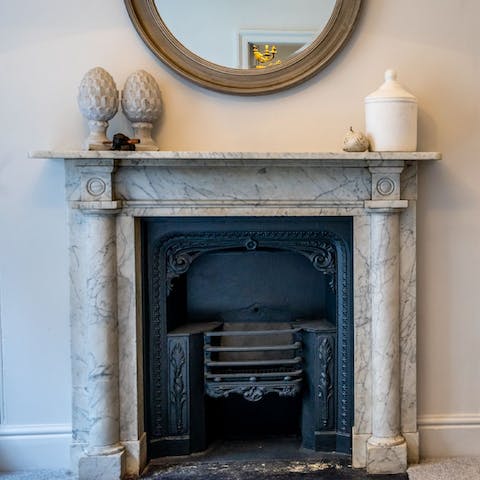 Admire elegant original features, such as the marble and iron fireplace