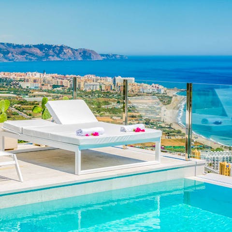 Admire incredible sea views as you sunbathe by the pool