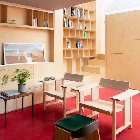 Admire the bespoke bookcases and handmade chairs inside