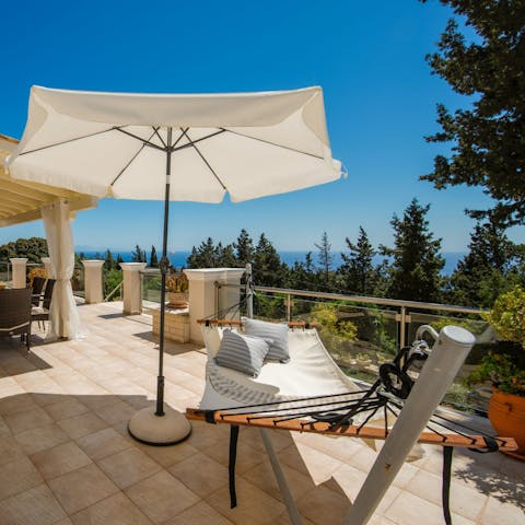 Lounge on the hammock with sea views in the distance