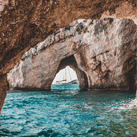 Explore the famous Blue Caves, a short drive away
