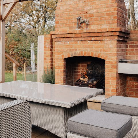 Keep snug and warm by the outdoor fireplace