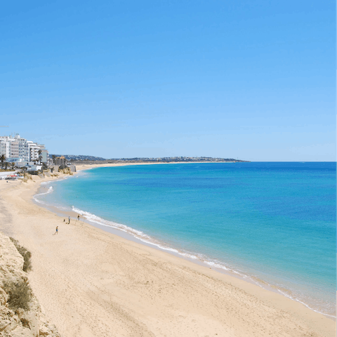 Wander down to the nearby town of Armação de Pêra and stop off at the beach