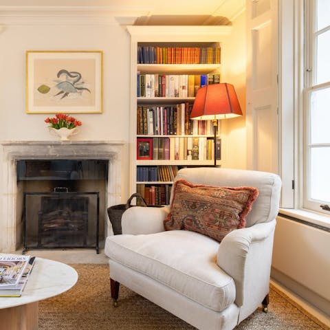 Curl up in the armchair with a book from the bookshelves