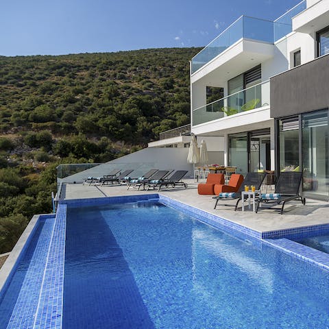 Admire the infinity pool and its majestic mountain backdrop