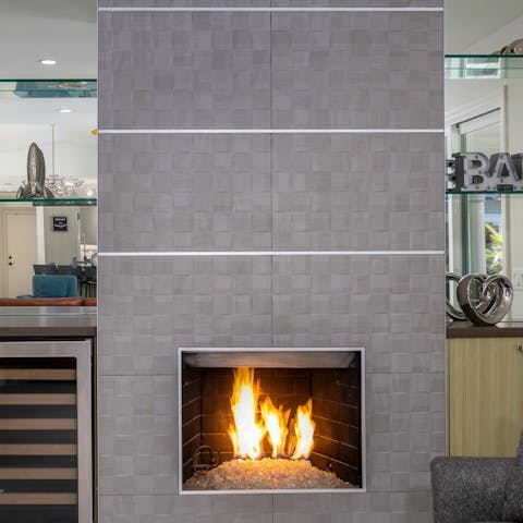 Two necessities for a cosy evening, the indoor fire pit and a wine fridge