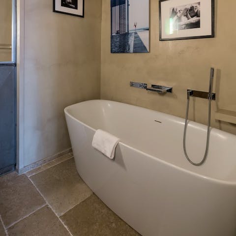 Savour a pre-dinner soak in the freestanding bathtub