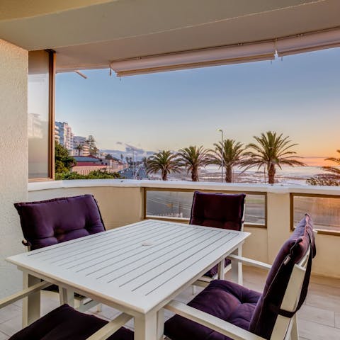 Sip a glass of South African wine at sunset while taking in ocean views from the private balcony