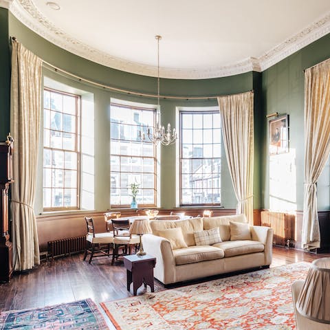 Sink into the plush sofa by the huge bay windows, a tumbler of whisky in hand