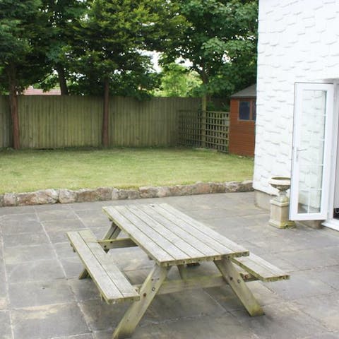 Enjoy a bite to eat at the picnic table in the garden