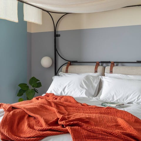 Drift to sleep in a king-size canopy bed 