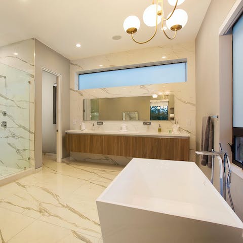 Sink into a hot bath in the luxurious marble bathroom