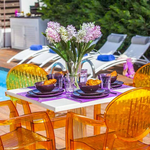 Dine alfresco poolside and toast drinks under the sun