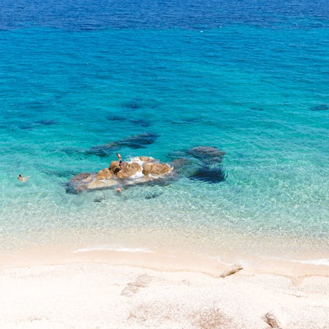 Take a three-minute drive to Agios Stefano beach