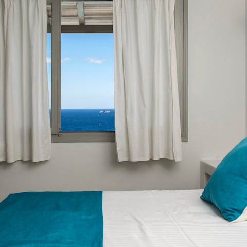 Wake up each morning and look out at the azure-hued Aegean Sea