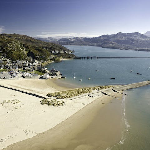 Go paddling at Barmouth Beach, a twenty-minute drive away