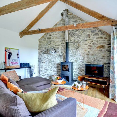 Snuggle up by the living room's wood-burner on cooler evenings, a glass of wine in hand