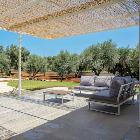 Relax with a book on the comfy outdoor sofas