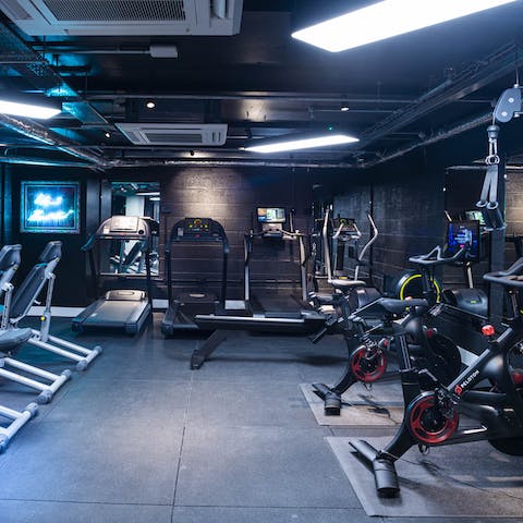 Bank a workout in the impressive shared gym with Peloton Bikes