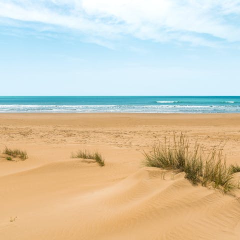 Sink into the soft sand of  Mannera Beach, mere footsteps away