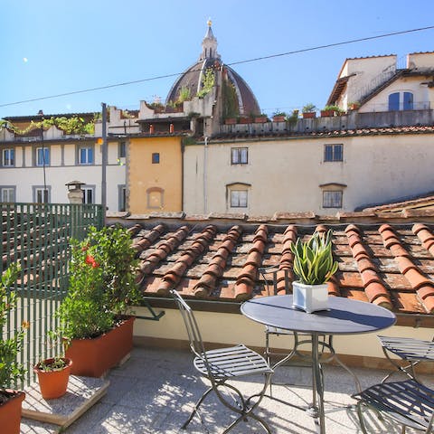 Enjoy a negroni cocktail on your private roof terrace with its views of the Duomo