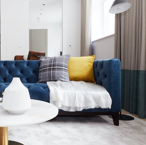 Sit yourself down on the stylish blue couch and take a moment to relax