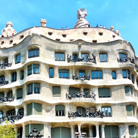 Ascend to the roof terrace of Casa Milà, only twelve minutes from home