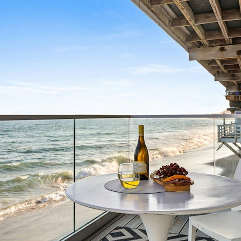Enjoy a glass of Californian rosé on the balcony and listen to the waves