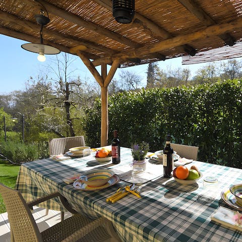 Gather around the dining table on the covered terrace for alfresco feasts