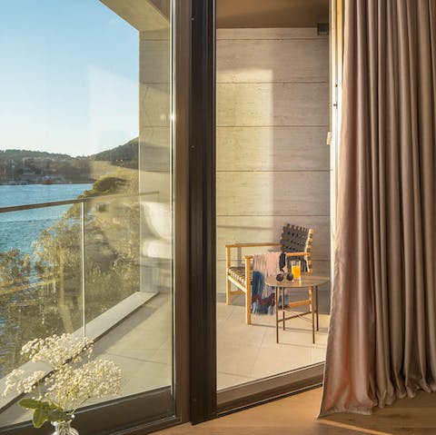 Sip rakija on the serene bedroom balcony, with glittering views of the Adriatic Sea