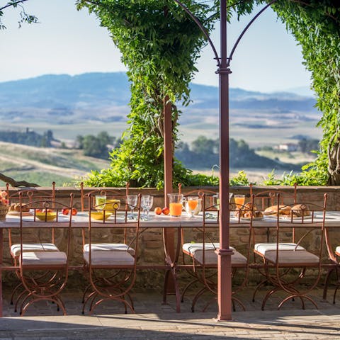 Dine alfresco under the loggia as wisteria frames the rolling hills