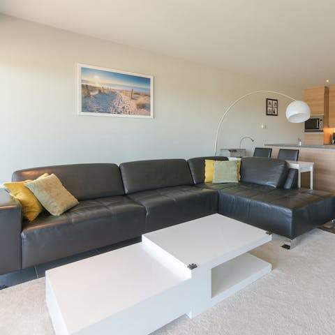 Get cosy in the living area and lounge about on the plush sofa 
