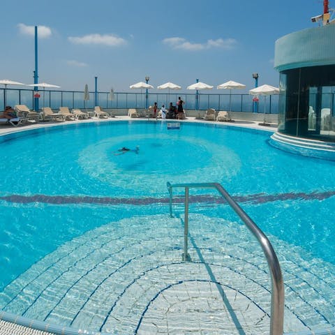 Swim in the glistening rooftop pool for a sense of true luxury