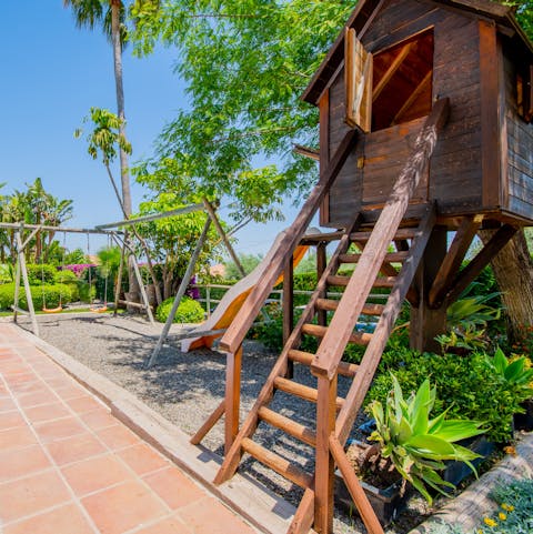 Let the kids run free at the play area with the cute little treehouse