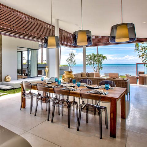 Revel in the merging of the outdoors and indoors around the table in the roofed, open-air living area