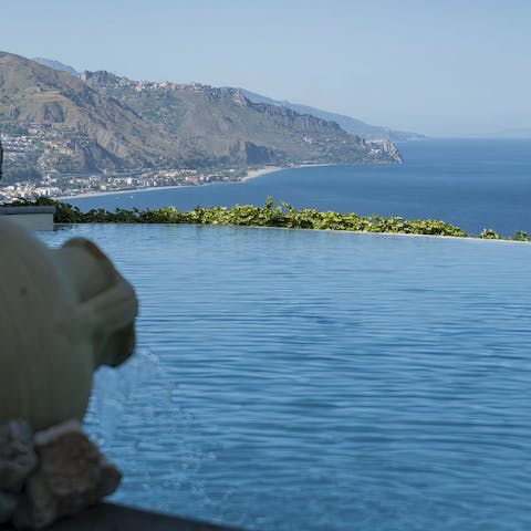 Soak in the cool of the infinity pool looking out over Sicily's coastline