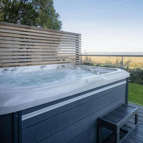 Unwind in the hot tub with a glass of Champagne and admire the sea views
