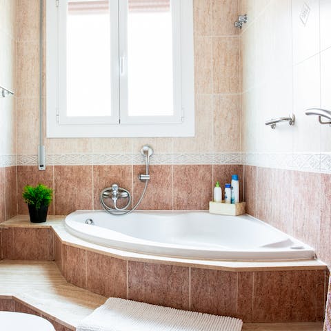 Unwind at the end of a fun-filled day of exploring the city in the huge corner bathtub 