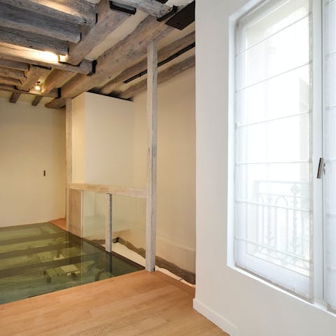 Admire this home's architectural features – ancient beams, original windows and a section of reinforced glass flooring