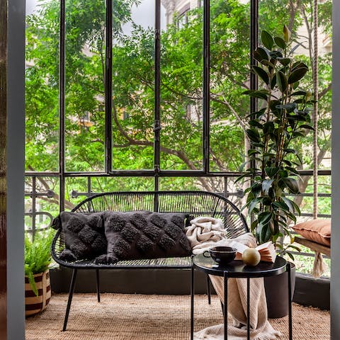 Enjoy a serene start to your morning with coffee on the glass-enclosed balcony