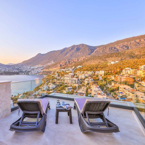Admire breathtaking views across the surrounding landscape from a lounger 