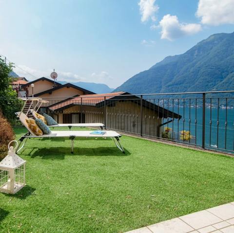Soak up the sunshine and vistas of the lake from a lounger on the terrace