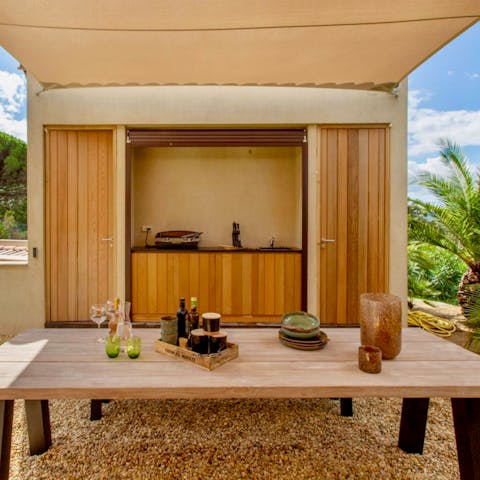 Eat, Swim, Repeat. Gather around the outdoor kitchen to make the most of your sunny days