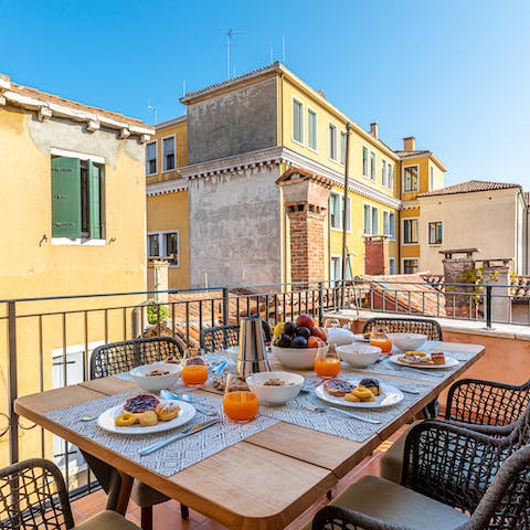 Enjoy an alfresco feast on the terrace, nestled in the Venetian rooftops